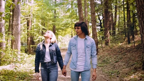 Young Couple Walking, Hand In Hand, Through Forest Stock Footage 89891802