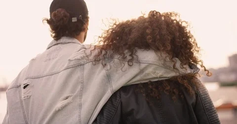 Young couple is walking at the harbor while sun is going down Stock Footage 85026004