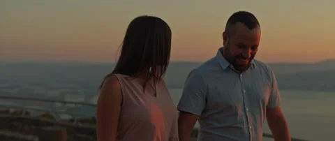 Young couple walking on the hill, talking to each other, laughing, having fun Stock Footage 136248209