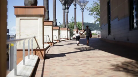Young couple walking holding hands Video stock 35482398
