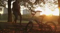 Young couple walking by kid's bike left in park, nostalgia for happy childhood HD Footage