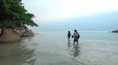 Young Couple Walking Knee-Deep in the Sea. Slow Motion Stock Footage 66318164