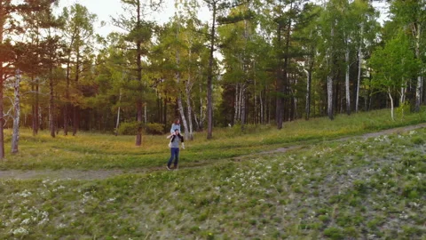 Young couple walking on a mountain path. Woman piggyback ride boyfriend. Video stock 111117942