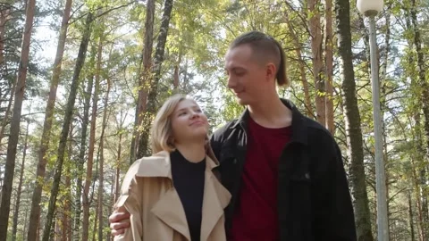 Young couple walking in a pine forest Video stock 314631596