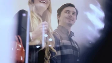 A young couple walking in a shopping centre looking at the shop windows. slow Stock Footage 85901366
