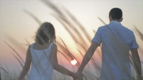 Young couple walking in sunset Stock Footage 7749218