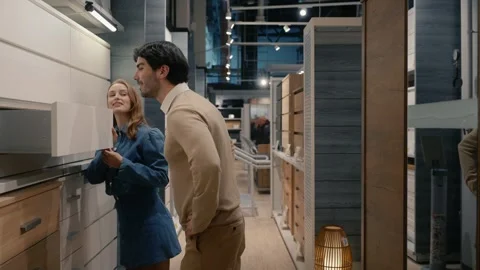 Young couple walking through the row in the stylish furniture store Stock Footage 311737948
