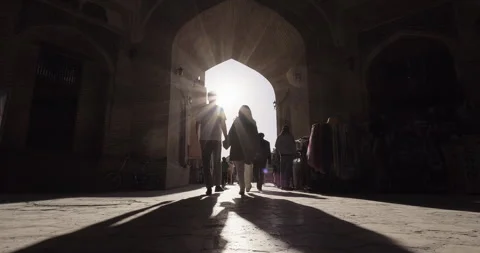 Young couple walking together through ancient streets of Bukhara, Uzbekistan Stock Footage 270982968