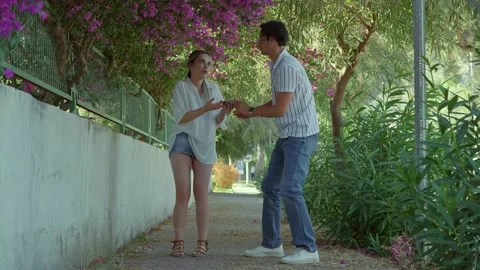 Young couple walking under a flowering tree. Stock Footage 166161436