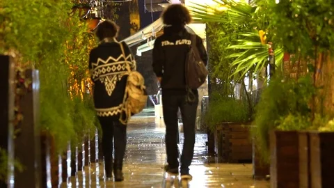 Young couple walking with under the rain in the old town Stock Footage 84107275