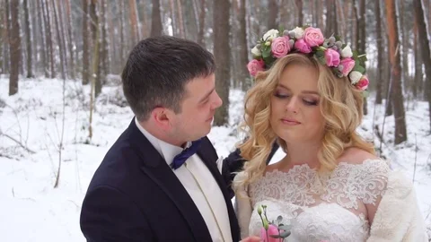 Young couple walking in winter forest holding hands and embracing in slow motion Stock Footage 83017319