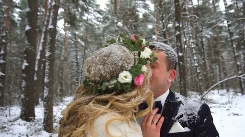 Young couple walking in winter forest holding hands and embracing in slow motion Stock Footage 83019932