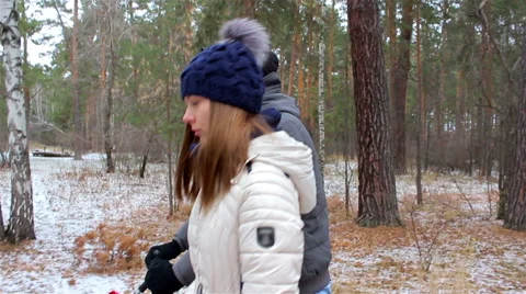 Young couple walking in the woods in first snow Stock Footage 56526055