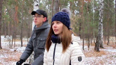 Young couple walking in the woods in first snow Stock Footage 56527535