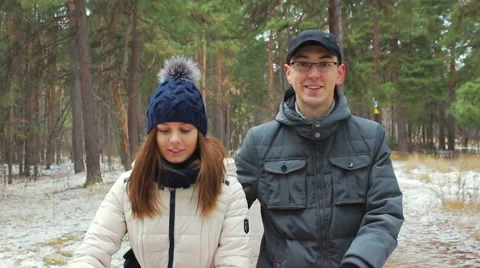 Young couple walking in the woods in first snow Stock Footage 56528403
