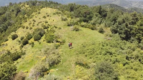 Young couple walks on a mountain path 動画素材 144521615