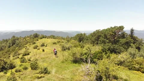 Young couple walks on a mountain path 動画素材 144521619