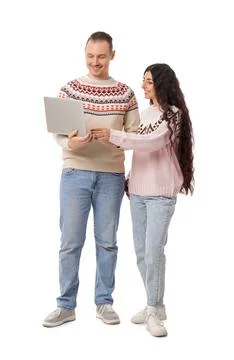 Young couple in warm sweaters using laptop on white background Stock Photos