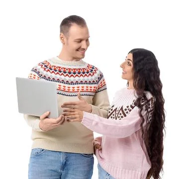 Young couple in warm sweaters using laptop on white background Stock Photos