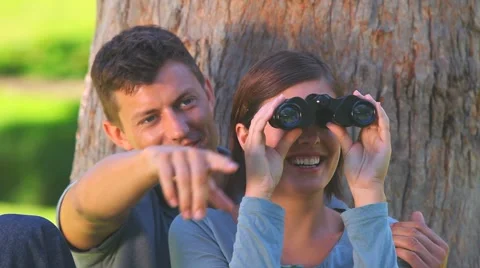 Young couple watching something through binoculars Stock Footage 2853248
