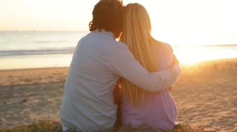 Young Couple Watching Sunset on Beach Centered Stock Footage 21833442