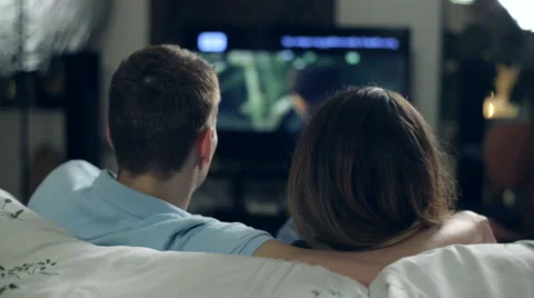 Young couple watching TV romantic Stock Footage