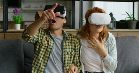Young couple wears vr headset, react emotionally on virtual reality images Stock Footage 114891094