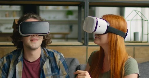 Young Couple Wears VR Headset at Home, Enjoying VR Images Stock Footage 115934161