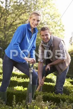 Young couple working in garden Stock Photos