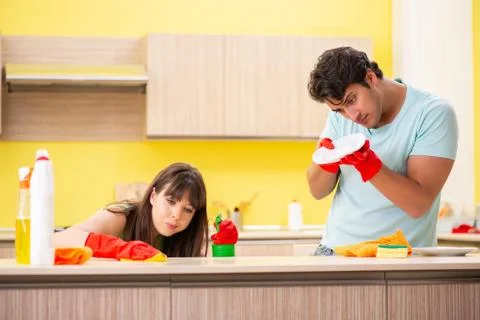 Young couple working at kitchen Stock Photos