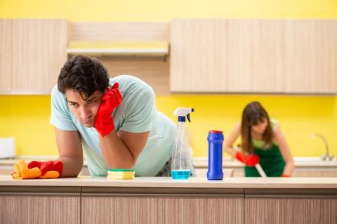 Young couple working at kitchen Fotos Stock