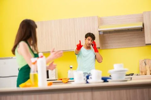 Young couple working at kitchen Fotos Stock