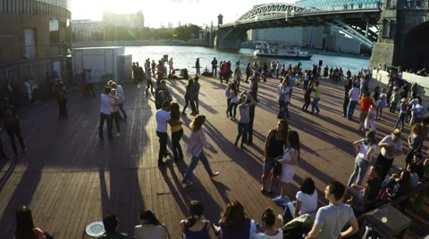 Young couples dance hustle in the evening in the street in the setting sun  Stock Footage 62575254