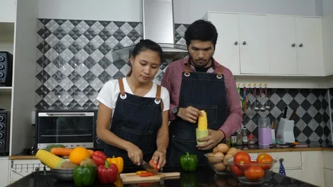 Young couples dancing and prepare food in the kitchen. Happy time. Stockbeeldmateriaal 98264705