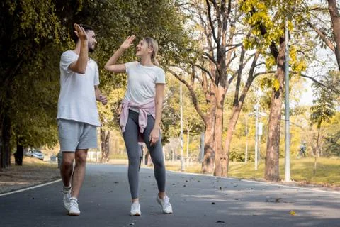 Young couples jogging in the park. Stock Photos