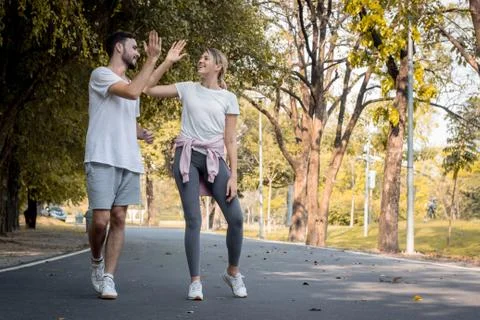 Young couples jogging in the park. Stock Photos