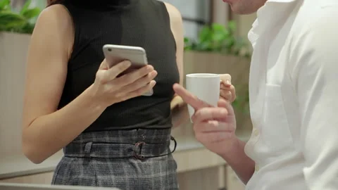 Young couples look at screens on mobile phones Stock Footage 146047211