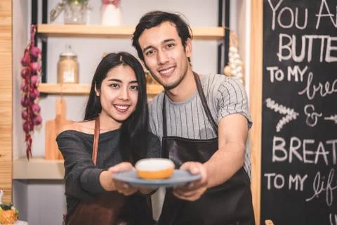 Young couples making bakery donuts and bread at bakery shop as business owner Фото