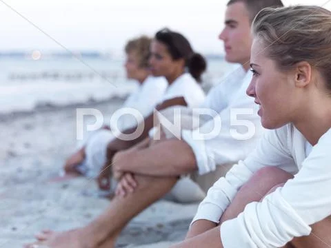 Young Couples Relaxing On Beach