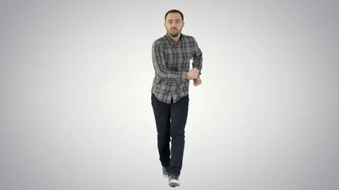 Young crazy man dancing and wanking forward on gradient background. Stock Photos