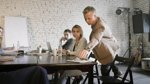 Young creative business team discussing the project while the team leader is Stock Footage 90487776