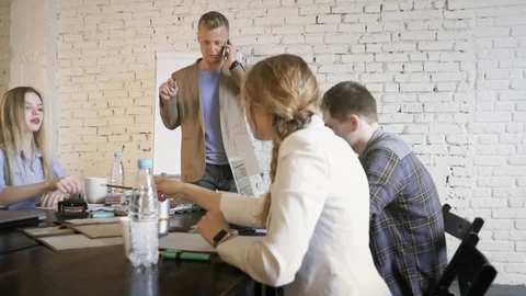 Young creative business team discussing the project while the team leader is Stock Footage 90487975