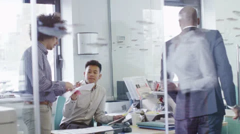 Young creative business team working together in a light contemporary office Stock Footage 25894647