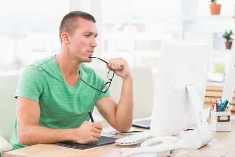 Young creative businessman working on the computer Foto stock