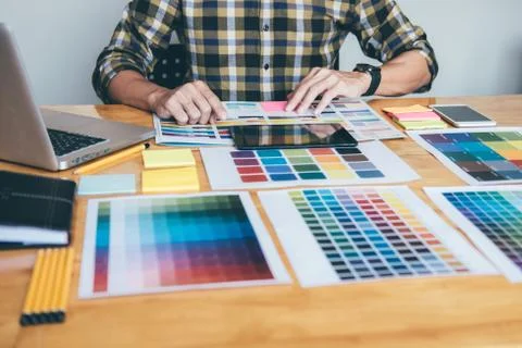 Young creative Graphic designer using graphics tablet to choosing Color swatc Stock Photos