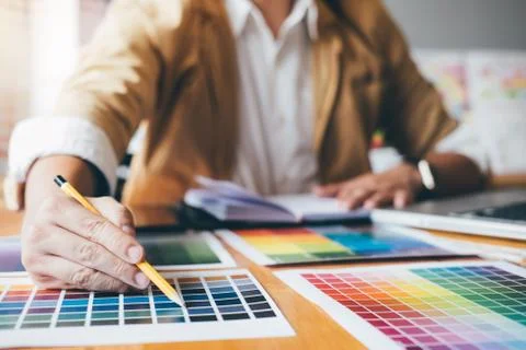 Young creative Graphic designer using graphics tablet to choosing Color swatc Stock Photos