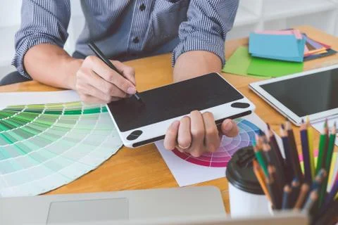 Young creative graphic designer working on project architectural drawing and Stock Photos