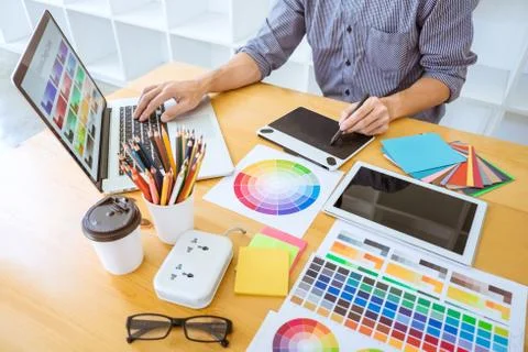 Young creative graphic designer working on project architectural drawing and Stock Photos