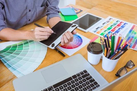 Young creative graphic designer working on project architectural drawing and Stock Photos