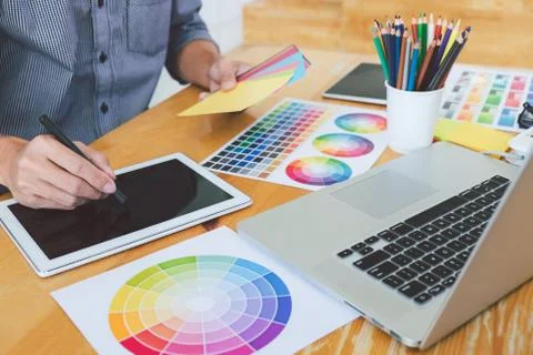 Young creative graphic designer working on project architectural drawing and Stock Photos